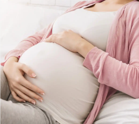 Pregnant woman representing reproductive and prenatal health testing